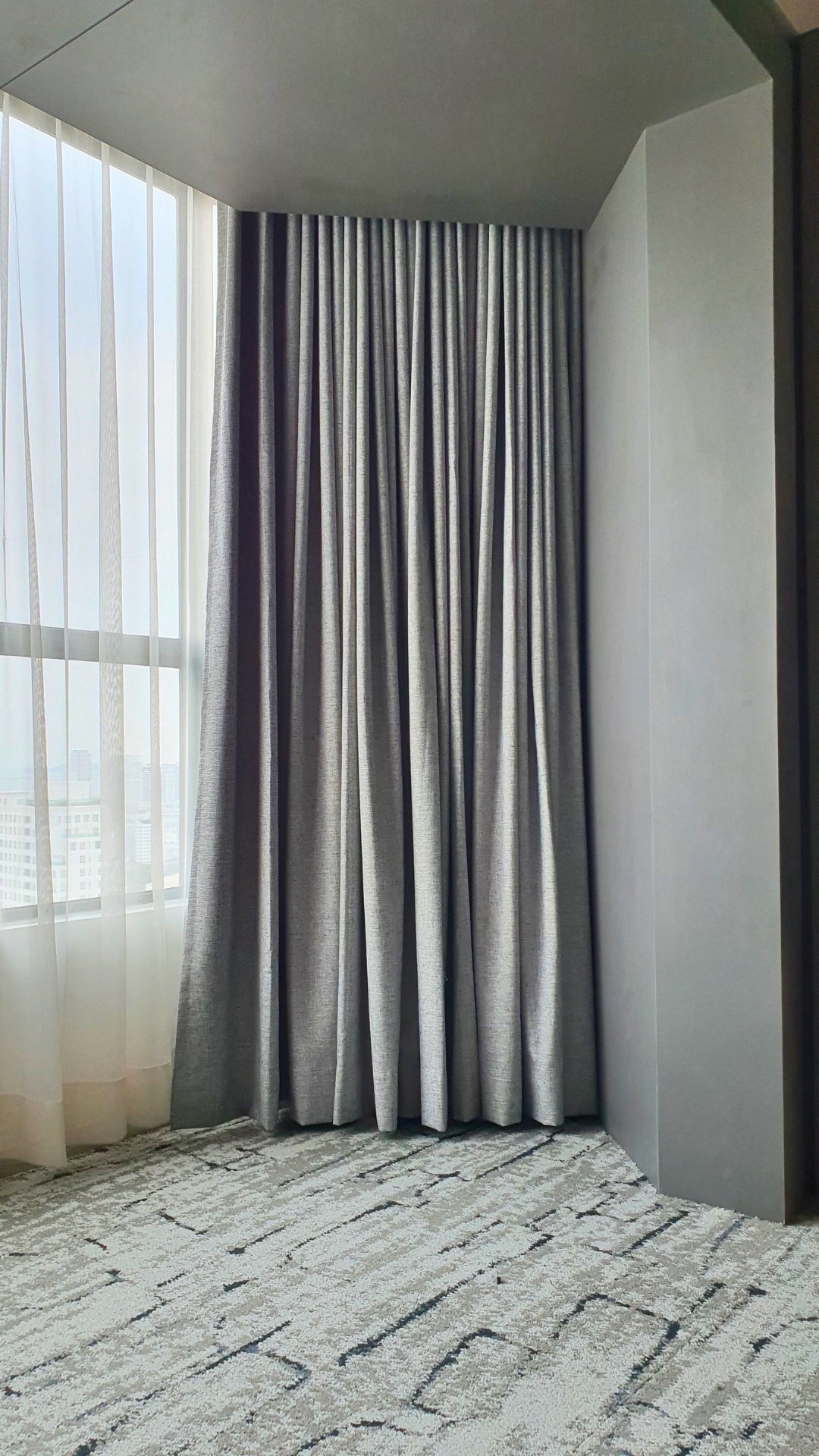 Full-height custom curtains in a coordinated Penang interior
